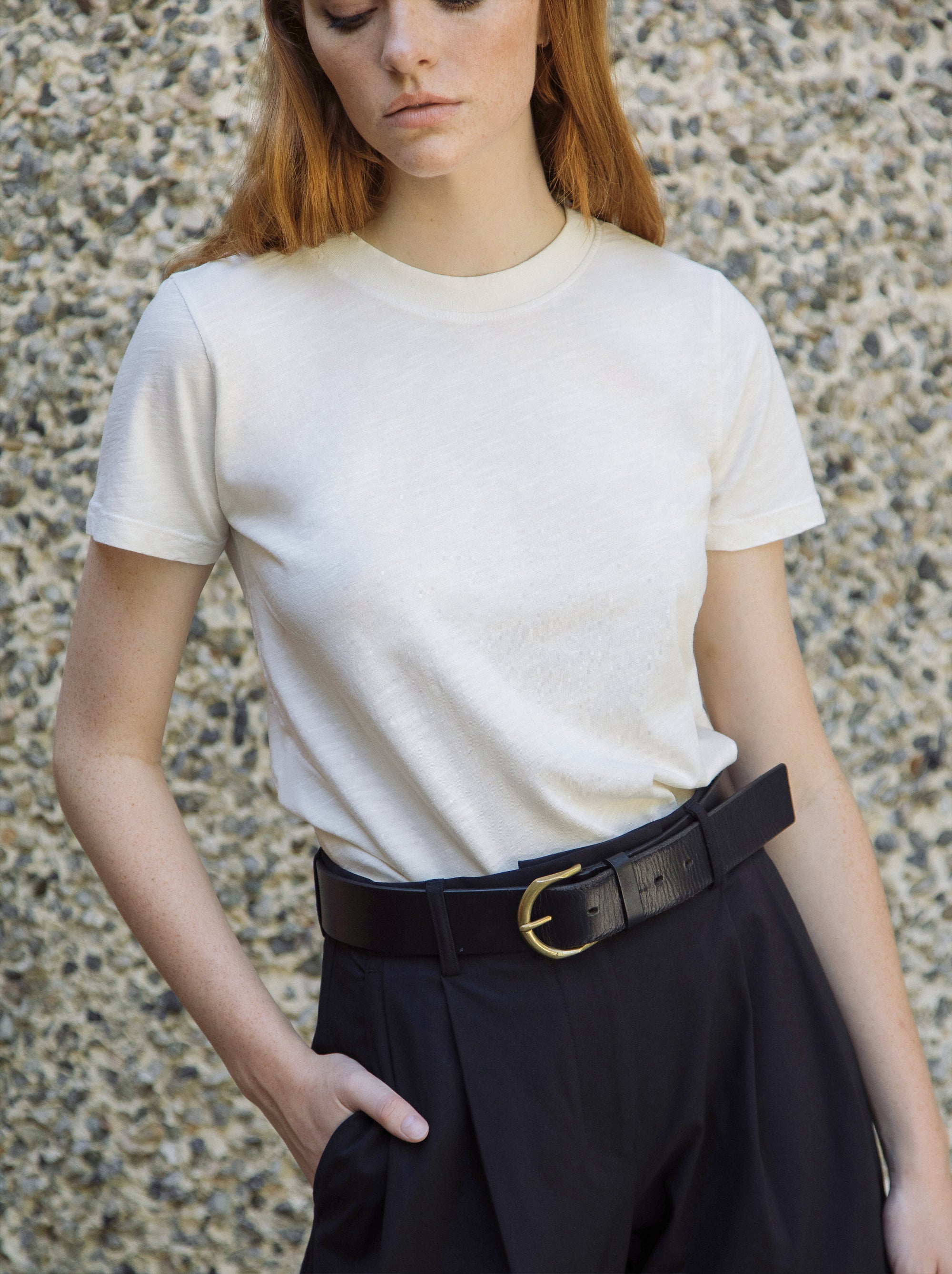 woman in a white t-shirt and black pants.